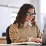Employee checking her health benefits information on a laptop