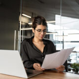 Employer reviewing GLP-1 coverage documents at her desk